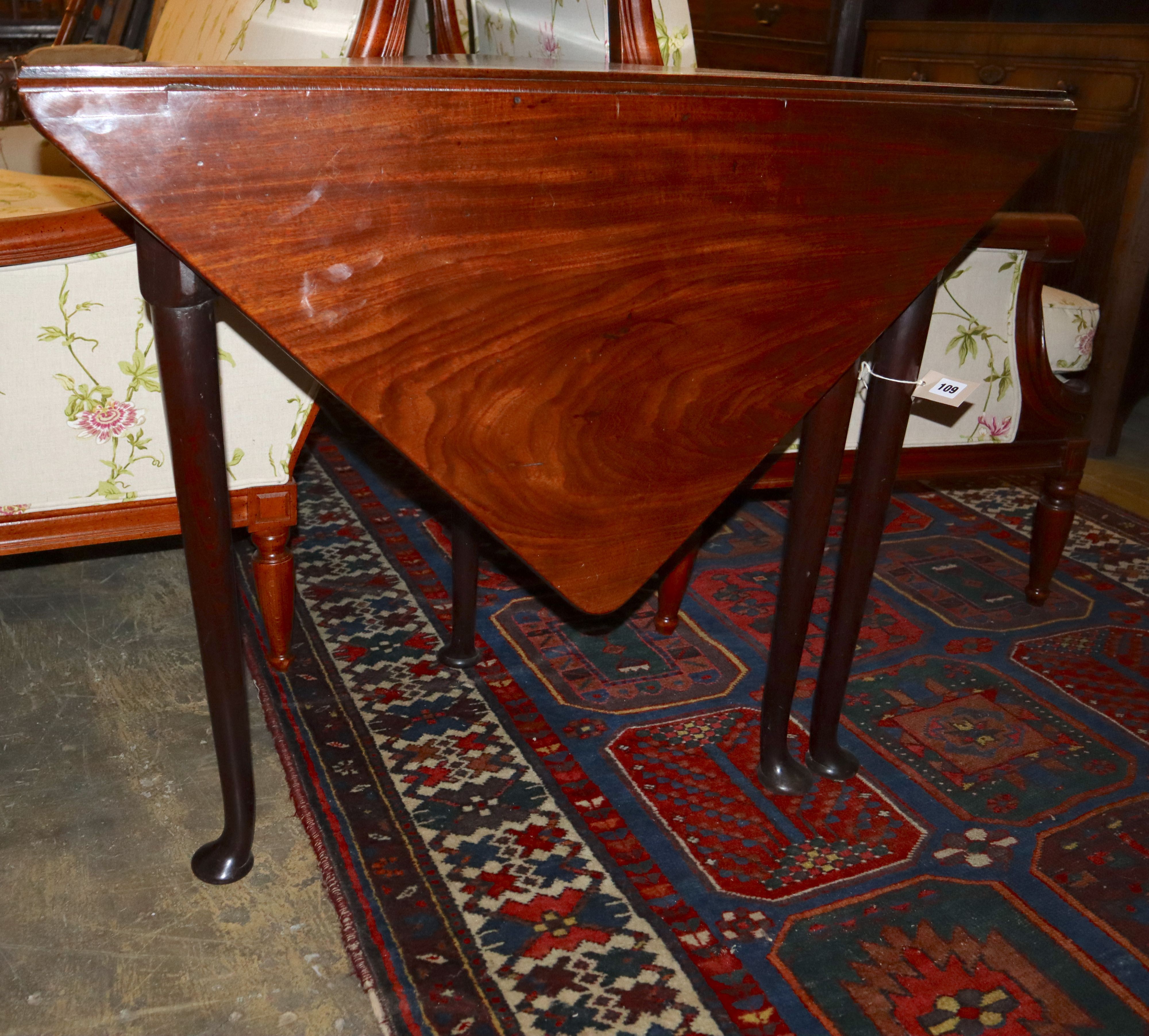 A George III mahogany triangular drop-leaf table, width 89cm, depth 46cm, height 72cm
